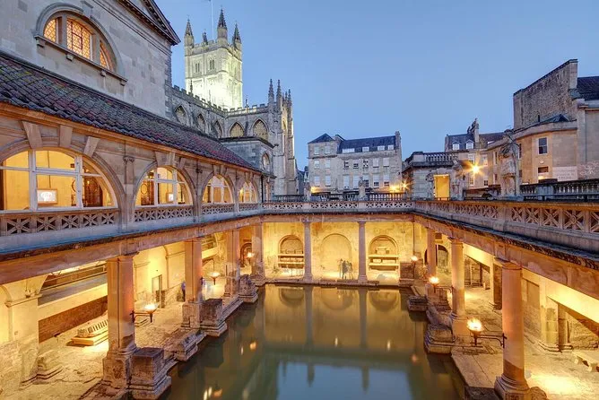The Roman Baths terrace lit up at dusk